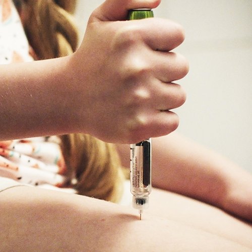 Child doing an insulin shot